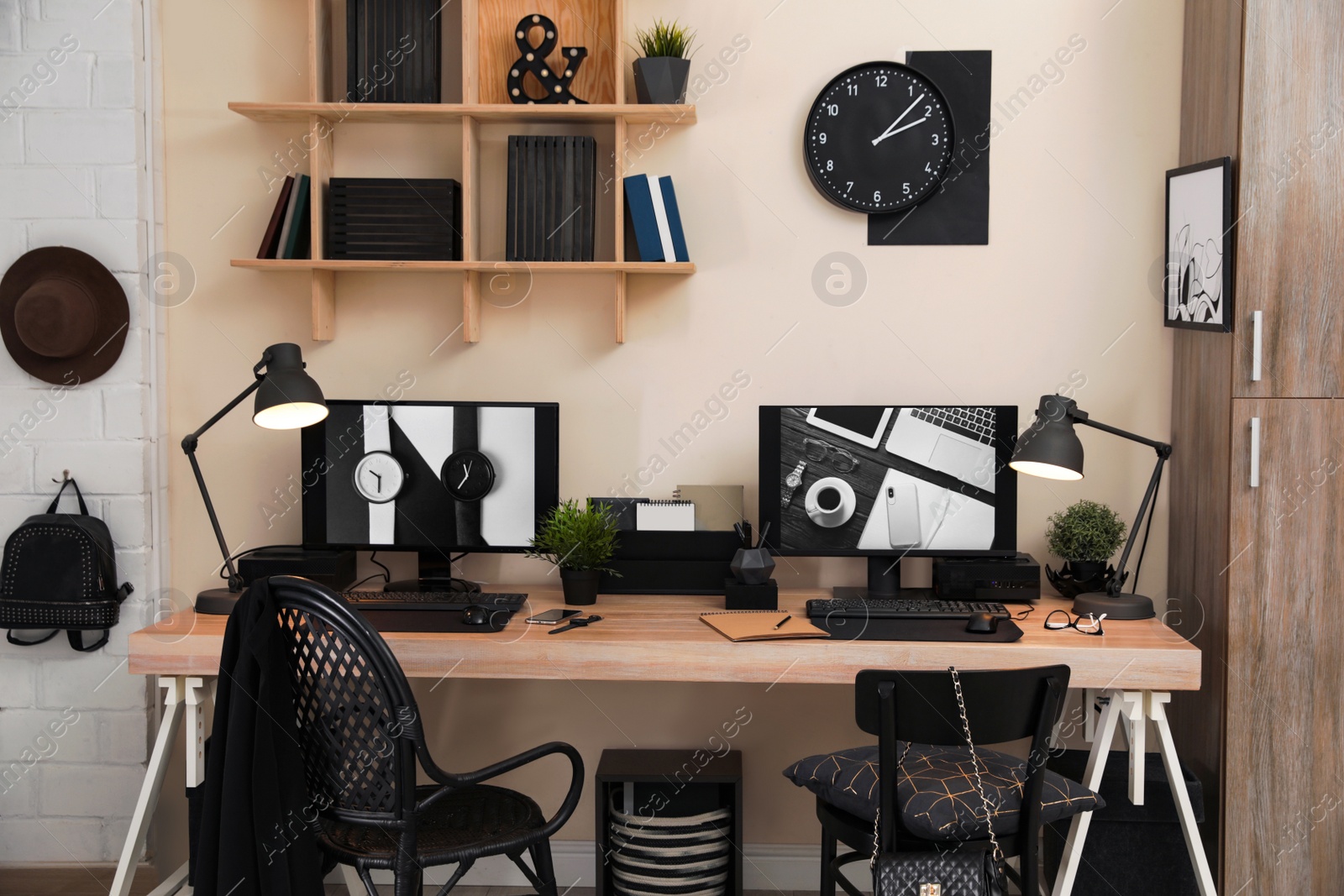 Photo of Stylish workplace interior with computers on table