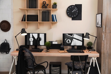 Stylish workplace interior with computers on table