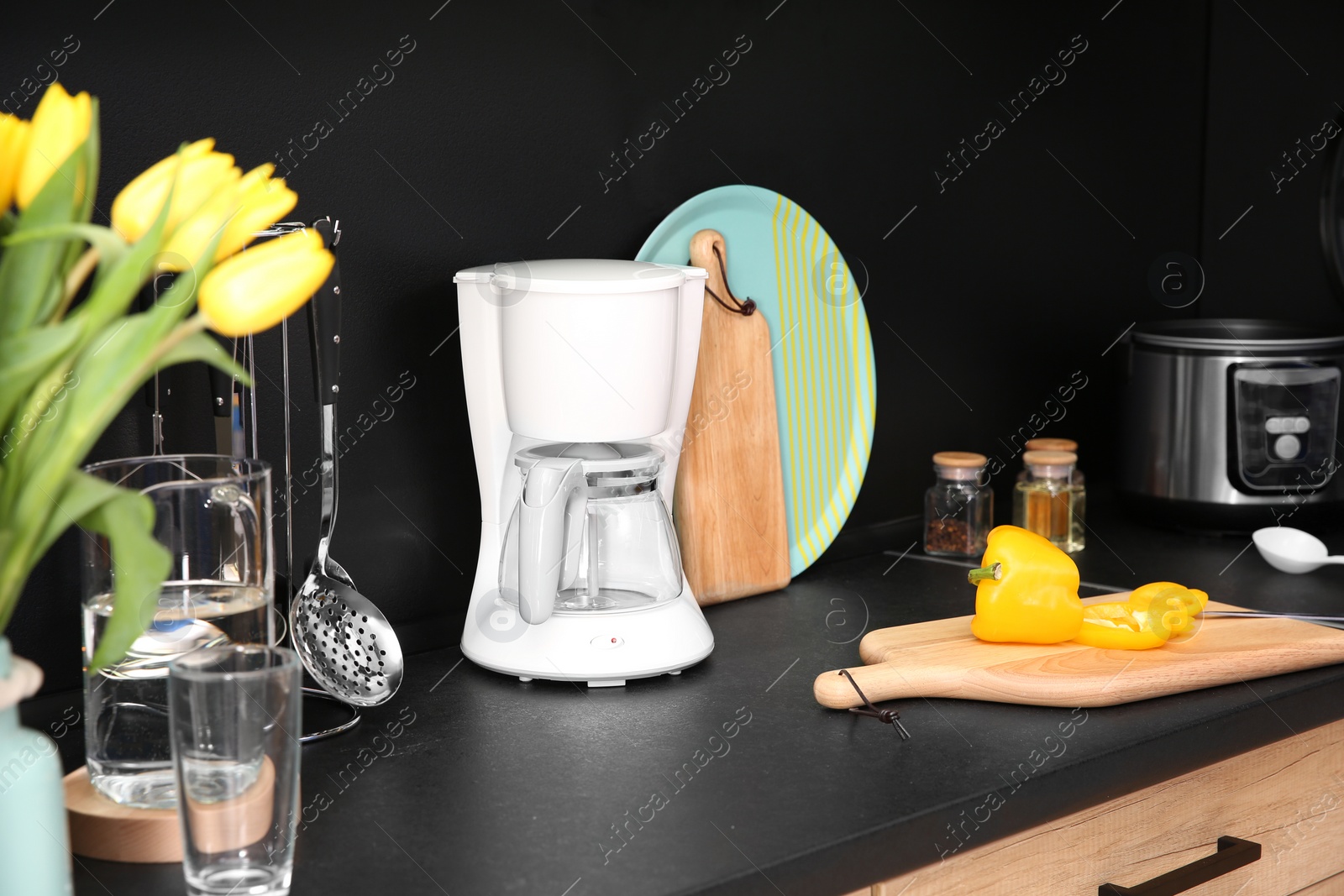 Photo of Stylish kitchen counter with houseware and appliances