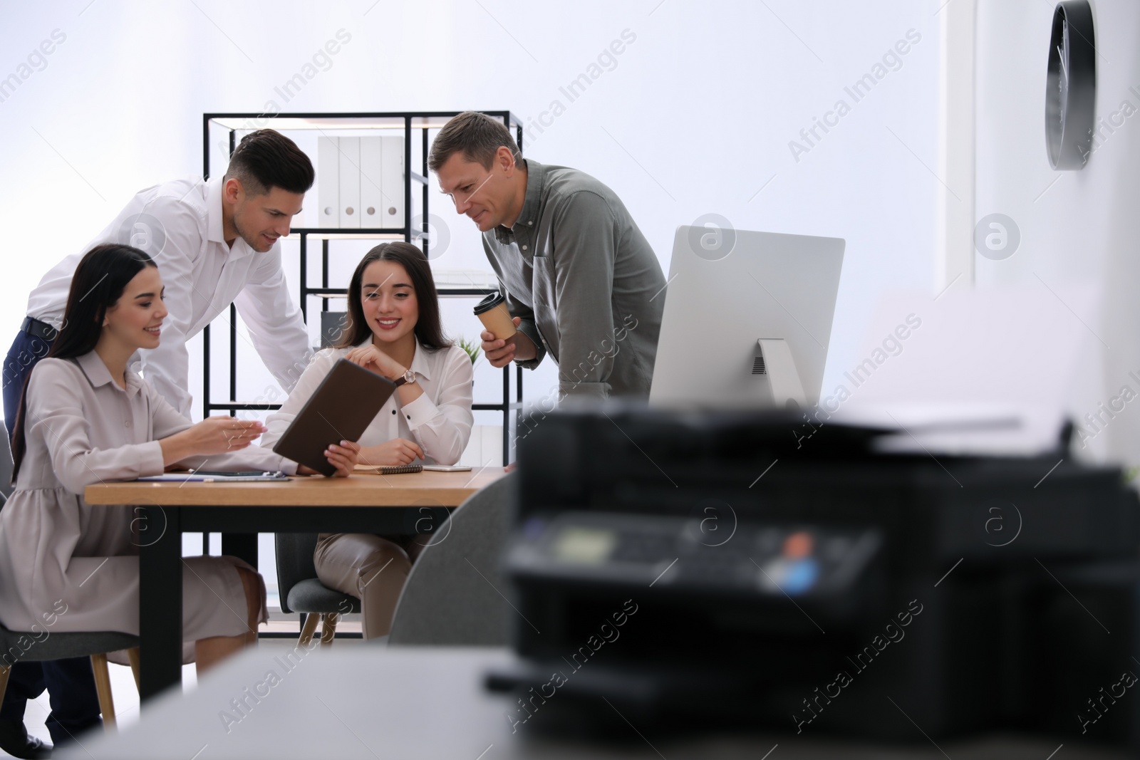 Photo of Group of employees working in modern office