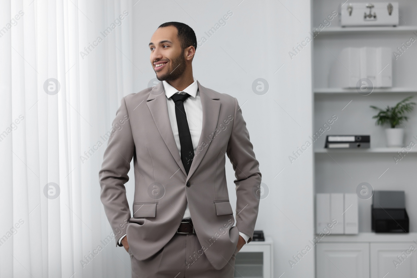 Photo of Portrait of smiling young man in office. Lawyer, businessman, accountant or manager