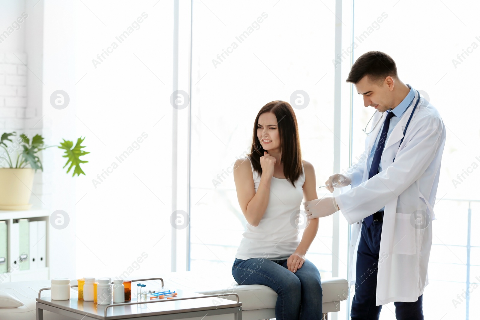 Photo of Doctor vaccinating female patient in clinic