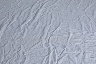 Photo of Crumpled white fabric as background, closeup view