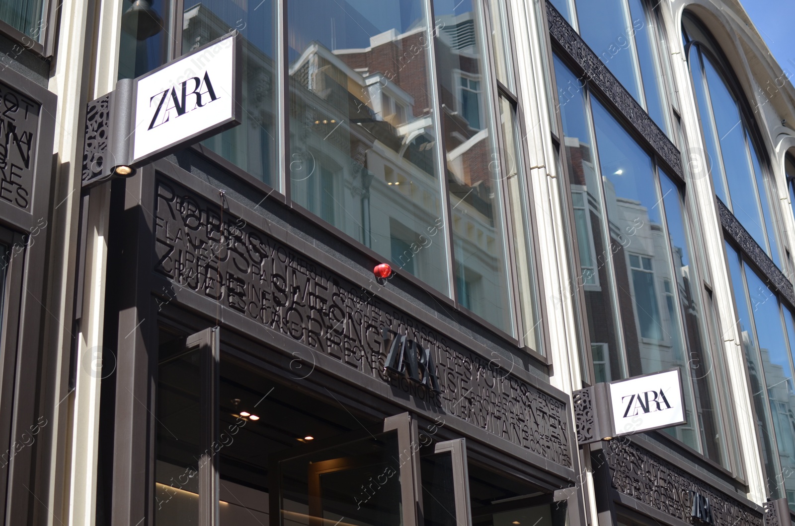 Photo of AMSTERDAM, NETHERLANDS - JULY 16, 2022: Official ZARA store on city street, low angle view