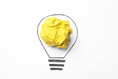 Creative idea. Drawing of lightbulb and crumpled yellow paper on white background, top view