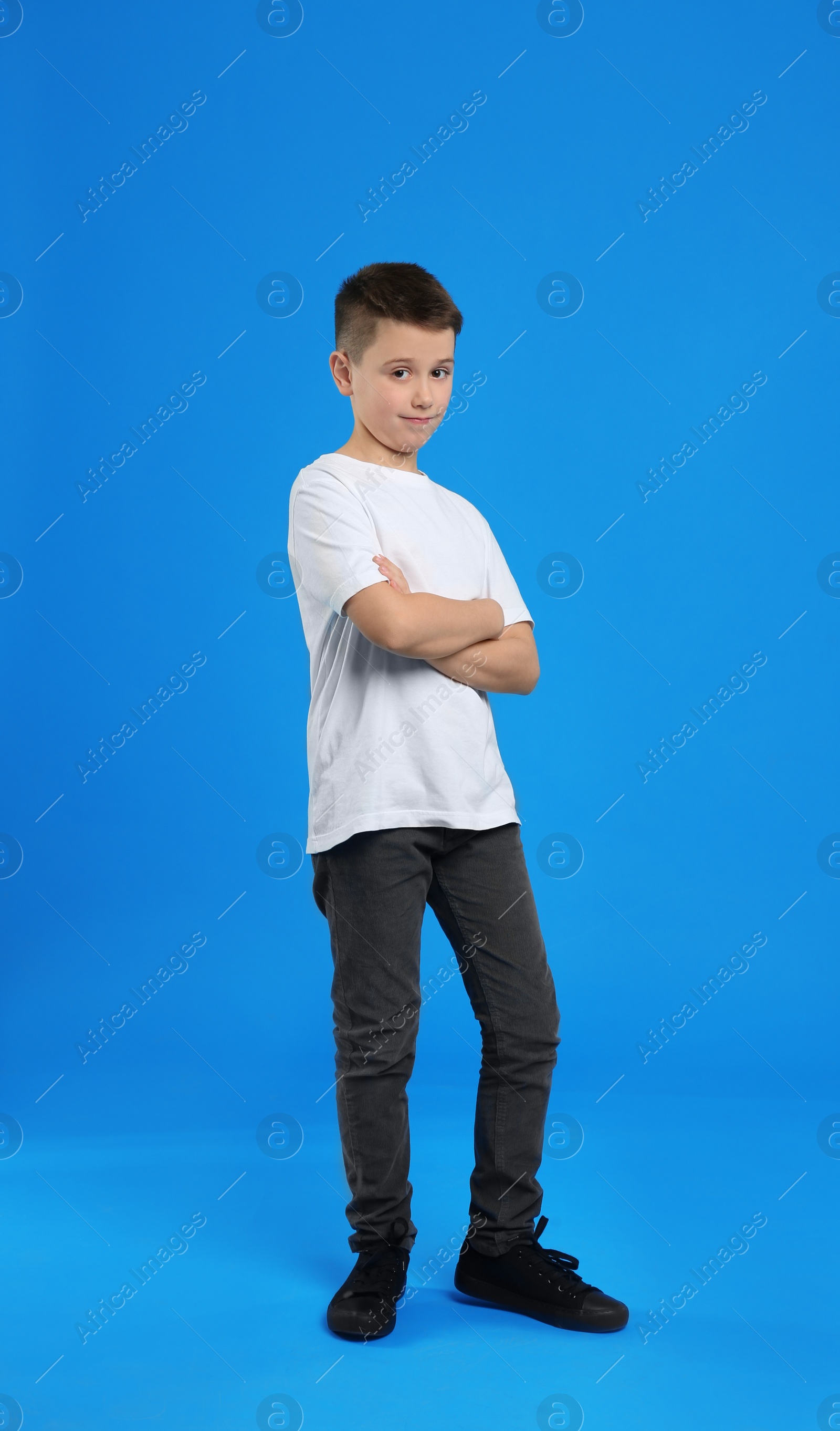 Photo of Full length portrait of preteen boy on light blue background