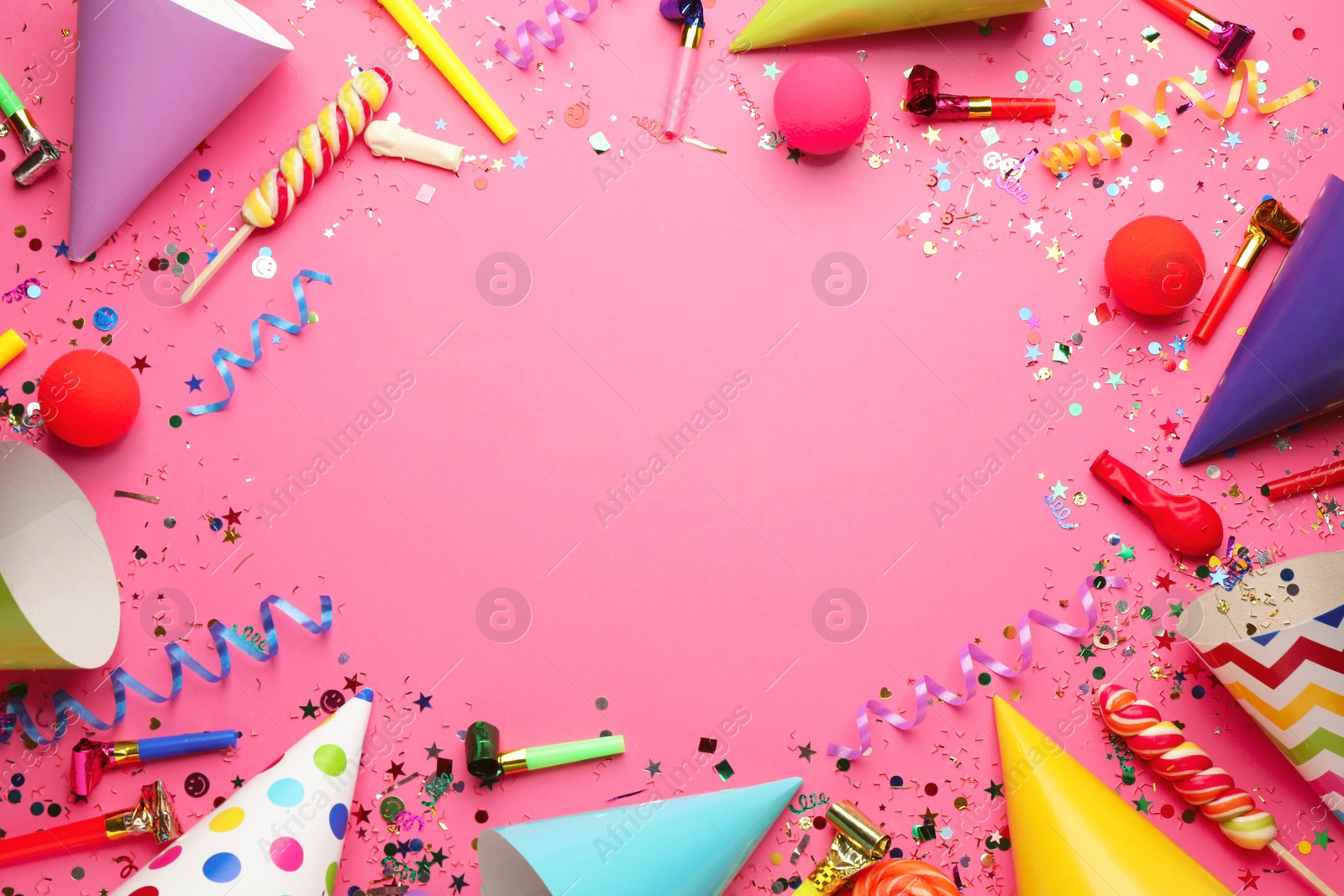 Photo of Frame of festive items on pink background, flat lay with space for text. Surprise party concept
