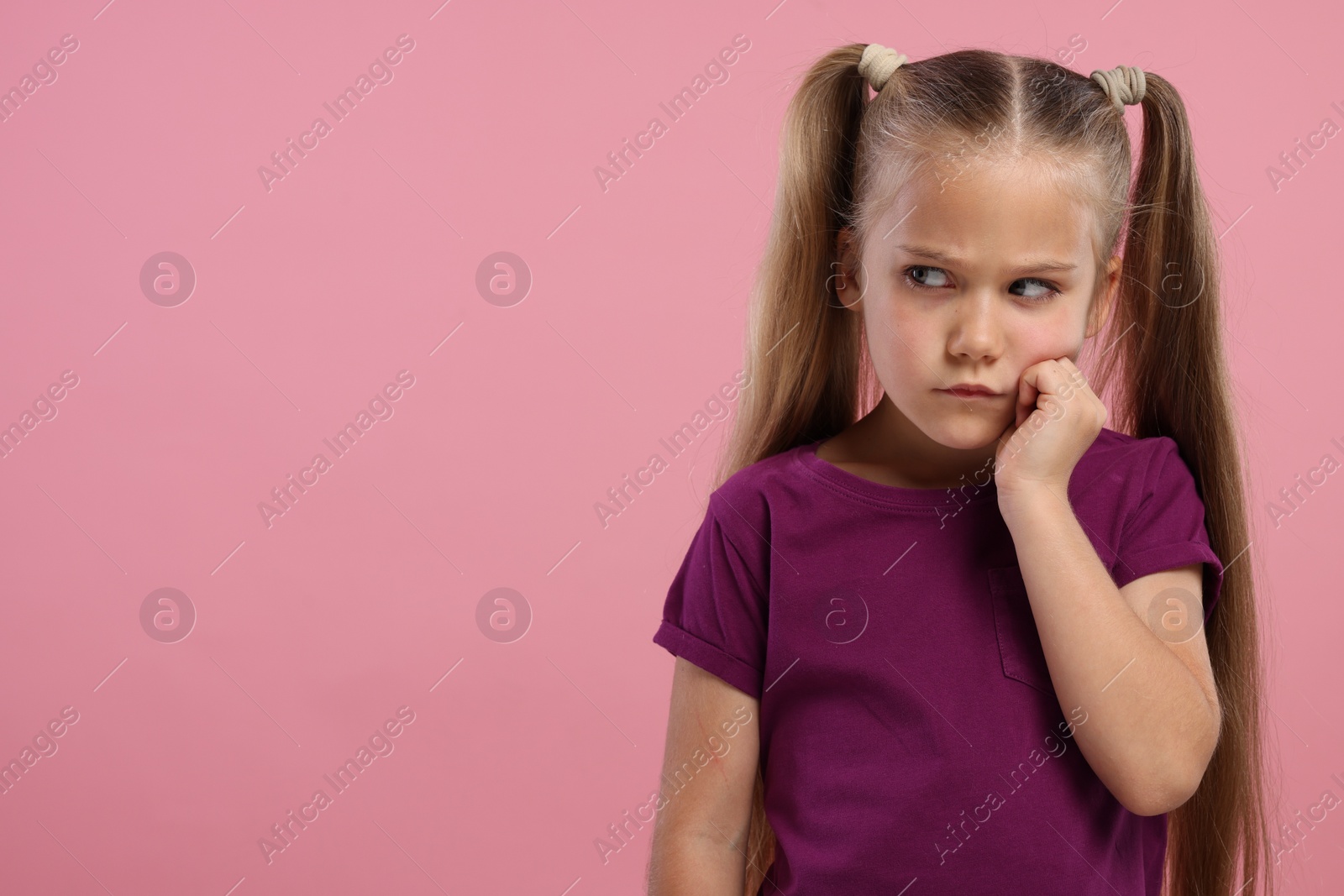 Photo of Resentful girl on pink background. Space for text