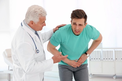 Photo of Man with health problems visiting urologist at hospital