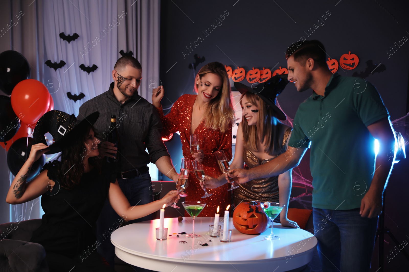 Photo of Group of friends having Halloween party at home