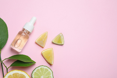 Photo of Flat lay composition with bottle of citrus essential oil on pink background. Space for text