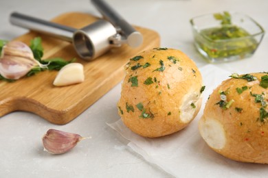 Photo of Traditional Ukrainian bread (Pampushky) with garlic on light table