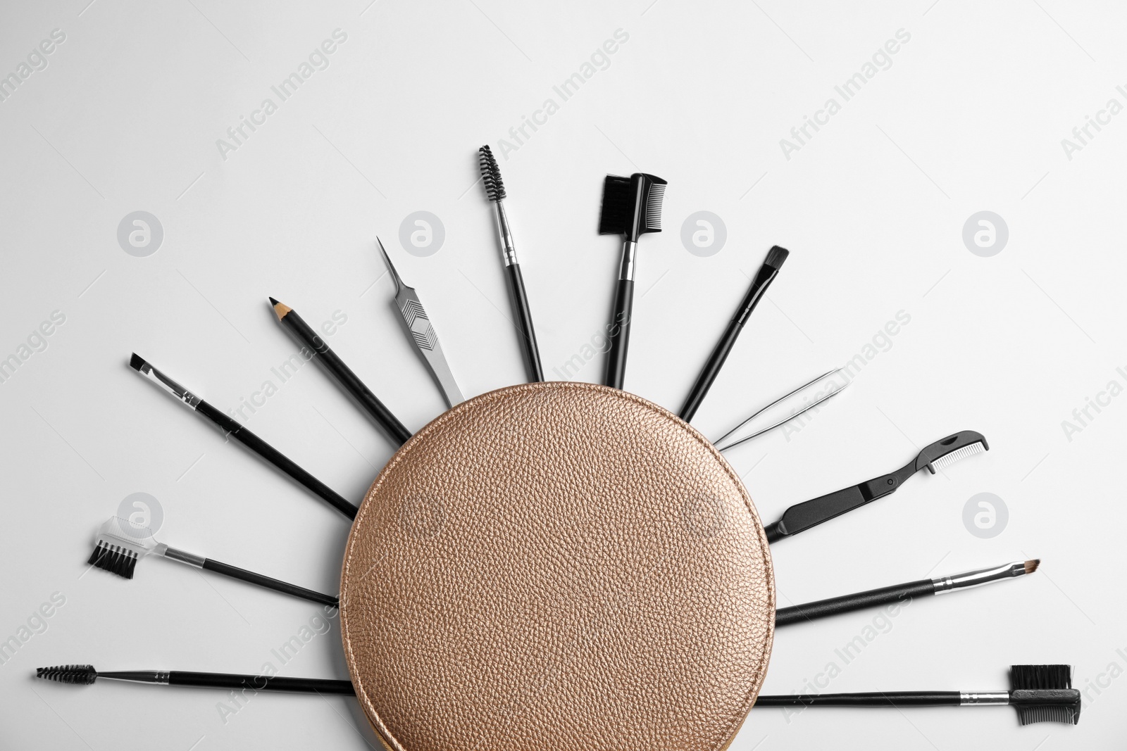 Photo of Set of professional eyebrow tools on white background, flat lay