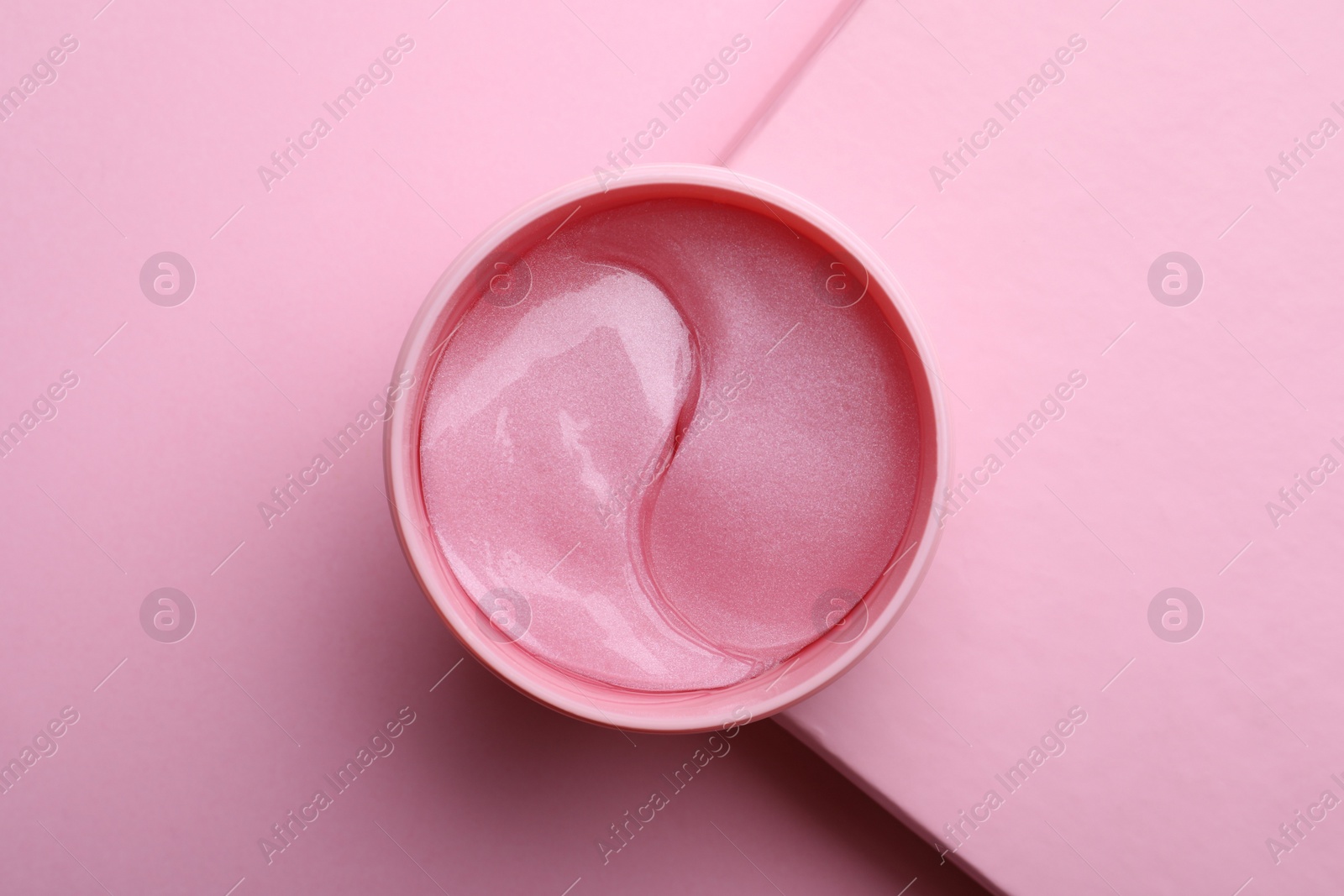 Photo of Package of under eye patches on pink background, top view. Cosmetic product