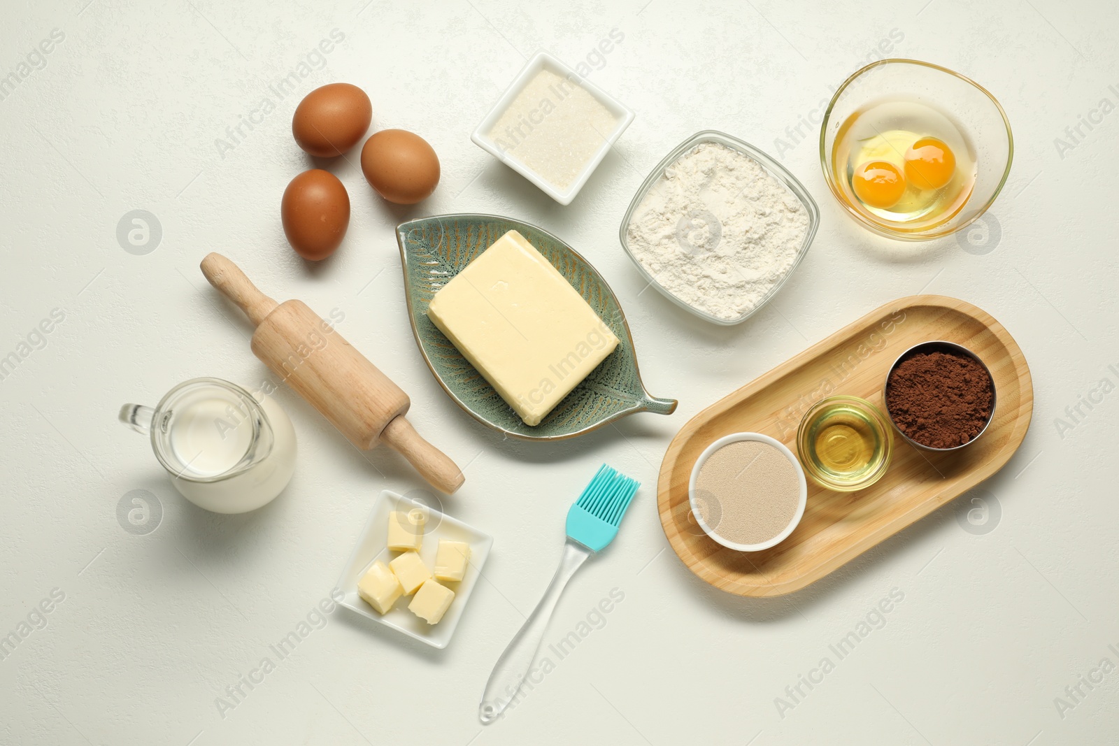 Photo of Flat lay composition with fresh butter among other products on white table