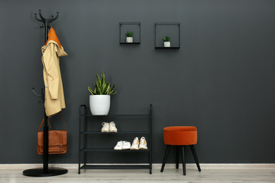 Photo of Hallway interior with stylish furniture, clothes and accessories