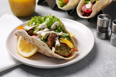 Photo of Delicious fresh vegan taco served on light grey marble table