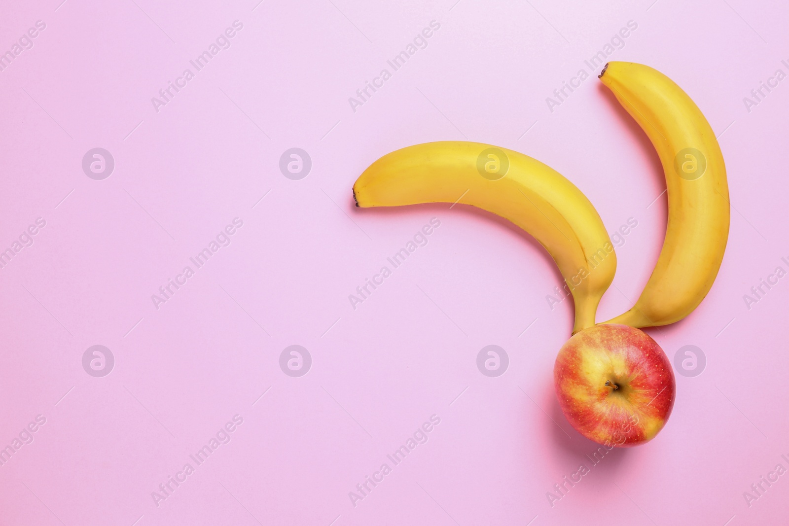 Photo of Tasty raw apple and bananas on pink background, flat lay with space for text