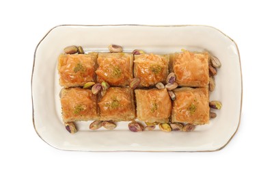 Photo of Plate of delicious baklava with pistachio nuts on white background, top view