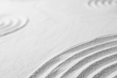 Photo of Zen garden pattern on sand. Meditation and harmony