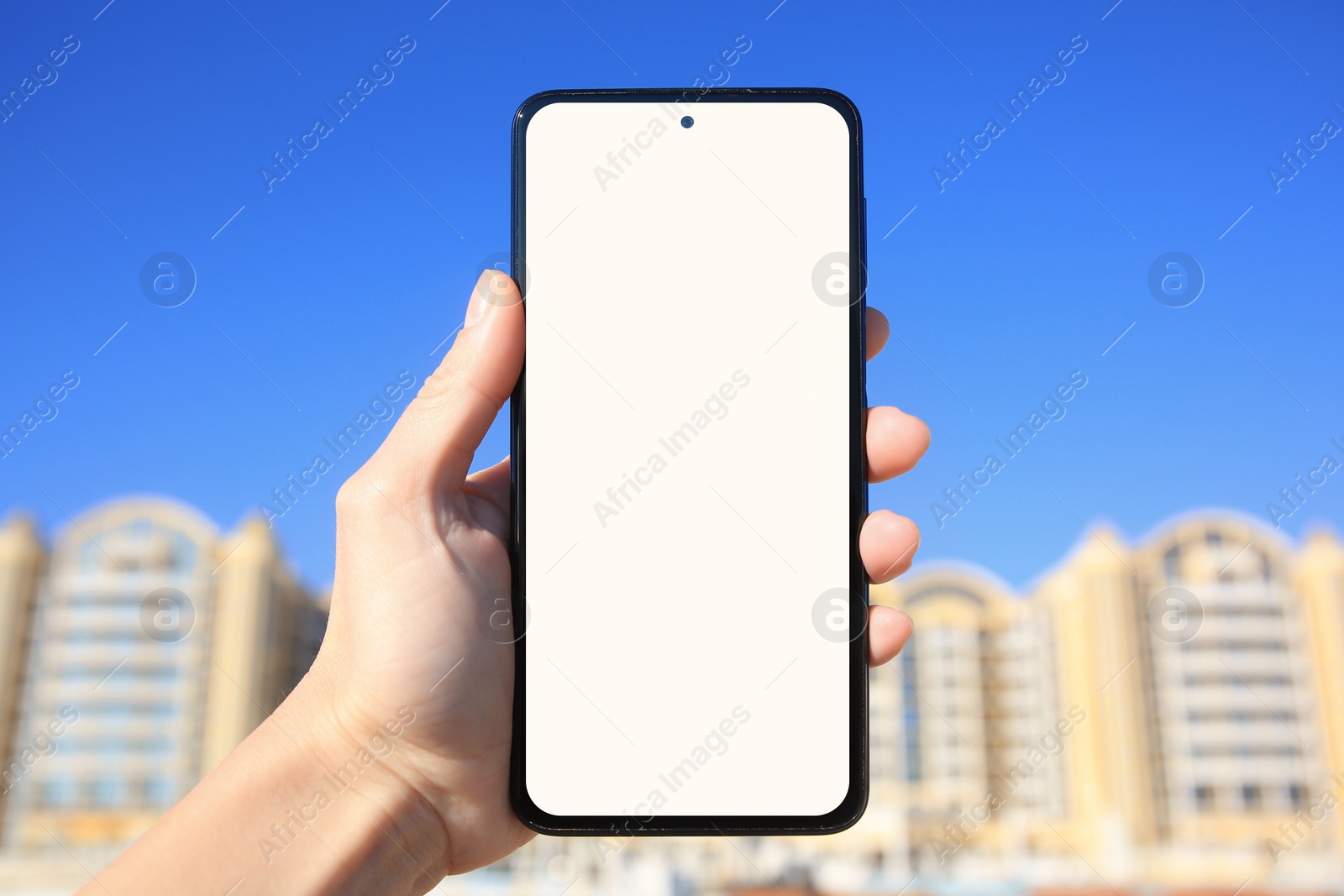 Photo of Man using weather forecast app on smartphone outdoors on sunny day, closeup