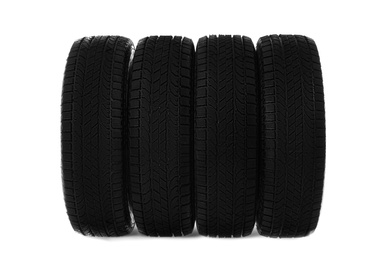 Set of new winter tires on white background