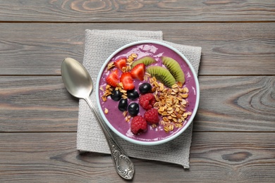 Delicious acai smoothie with fruits served on grey wooden table, top view