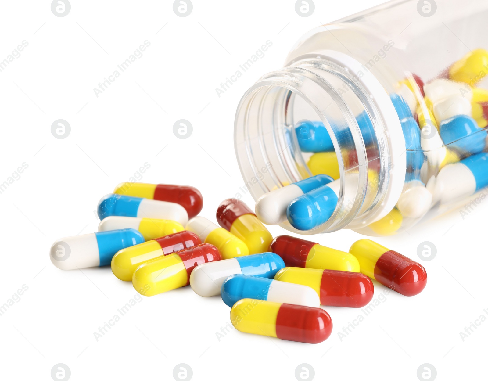 Photo of Scattered antibiotic pills and bottle isolated on white