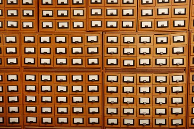 Many library card catalog drawers as background