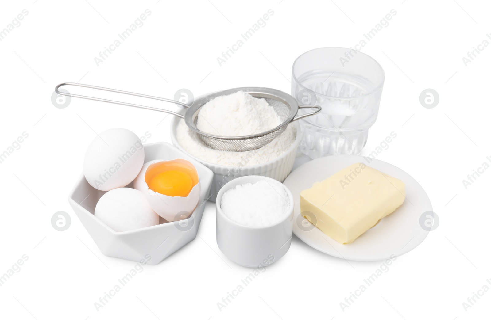 Photo of Eggs, butter, flour, salt and water isolated on white. Ingredients for puff pastry dough