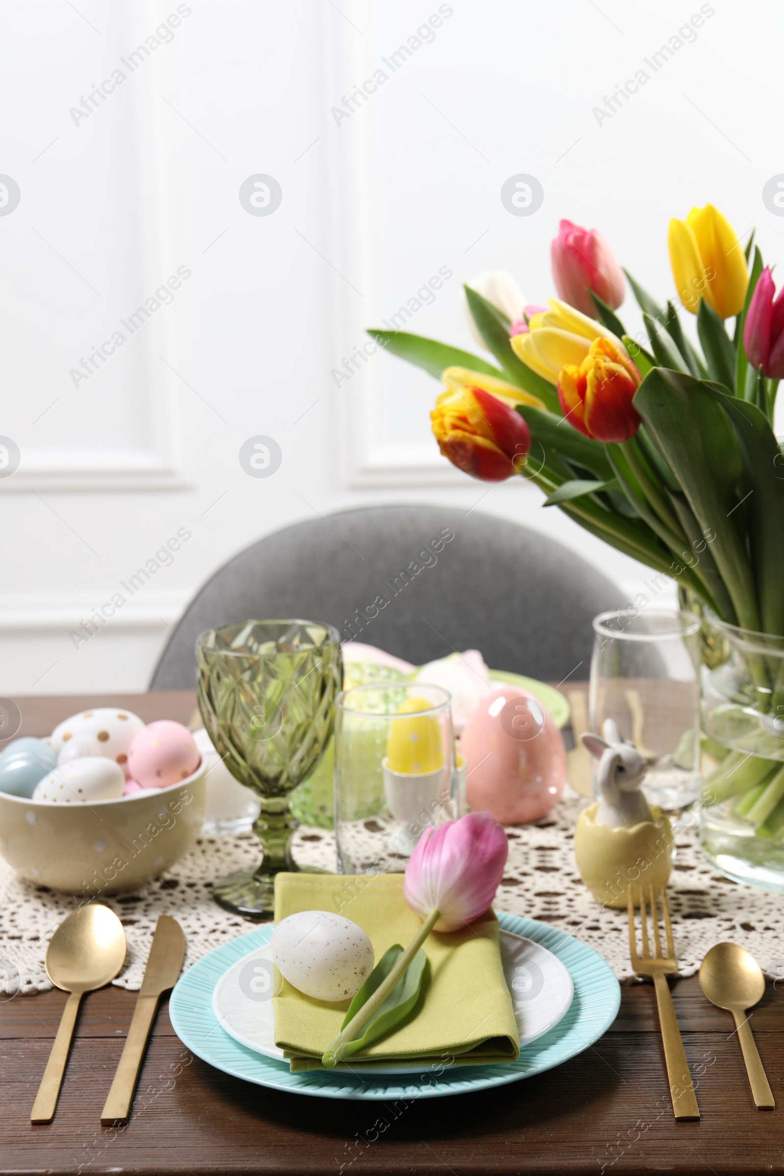 Photo of Festive table setting with beautiful flowers. Easter celebration