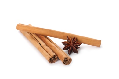 Photo of Aromatic cinnamon sticks and anise isolated on white