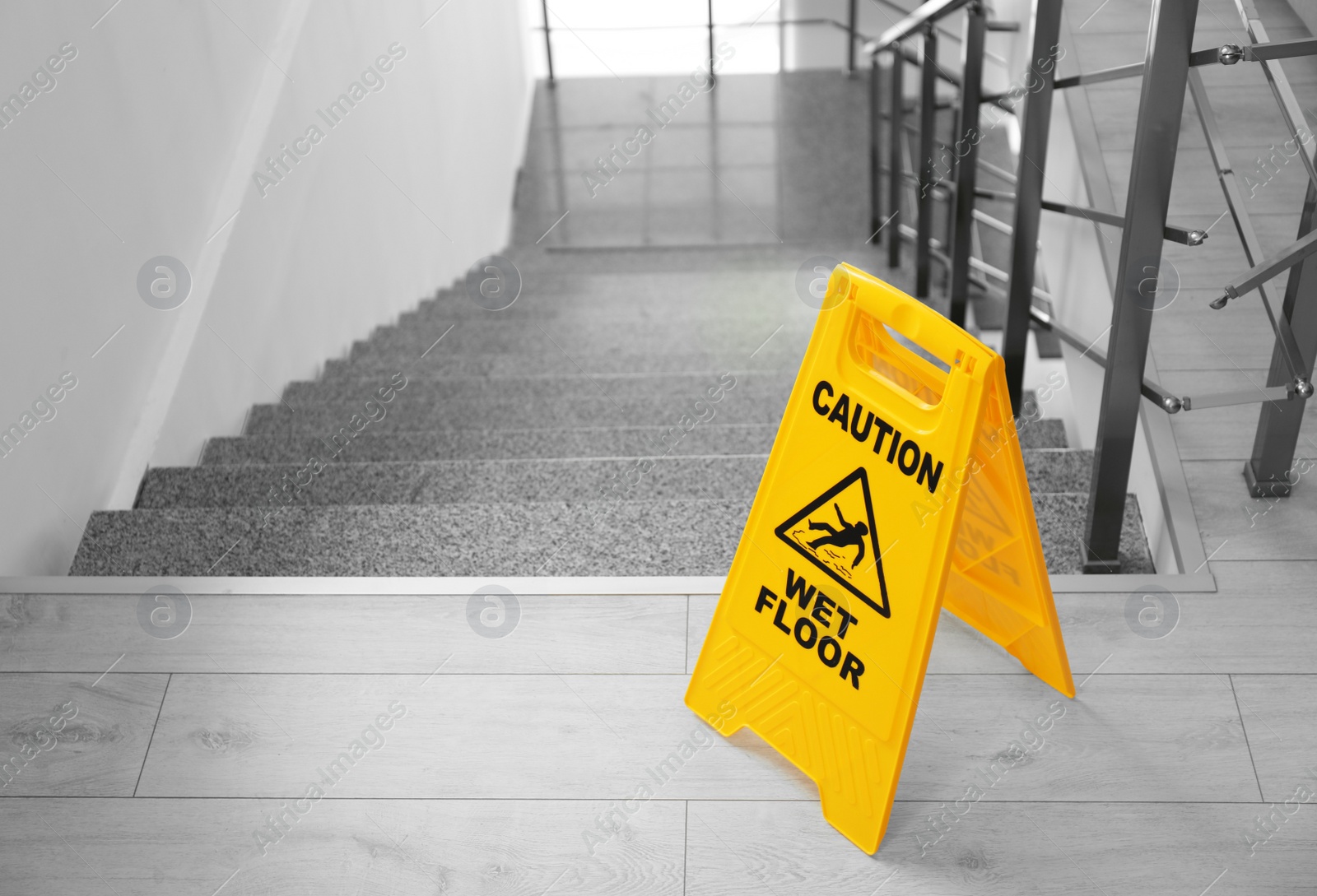 Photo of Safety sign with phrase Caution wet floor near stairs. Cleaning service