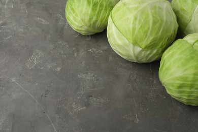 Photo of Ripe white cabbage on grey table. Space for text