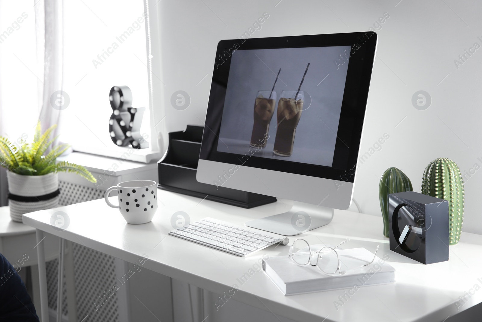 Photo of Comfortable workplace with computer on desk in home office