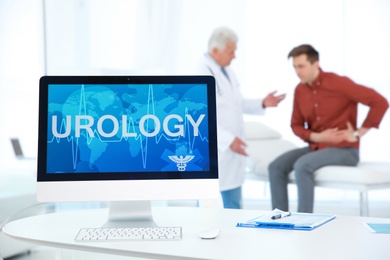 Computer monitor with word UROLOGY and people on background