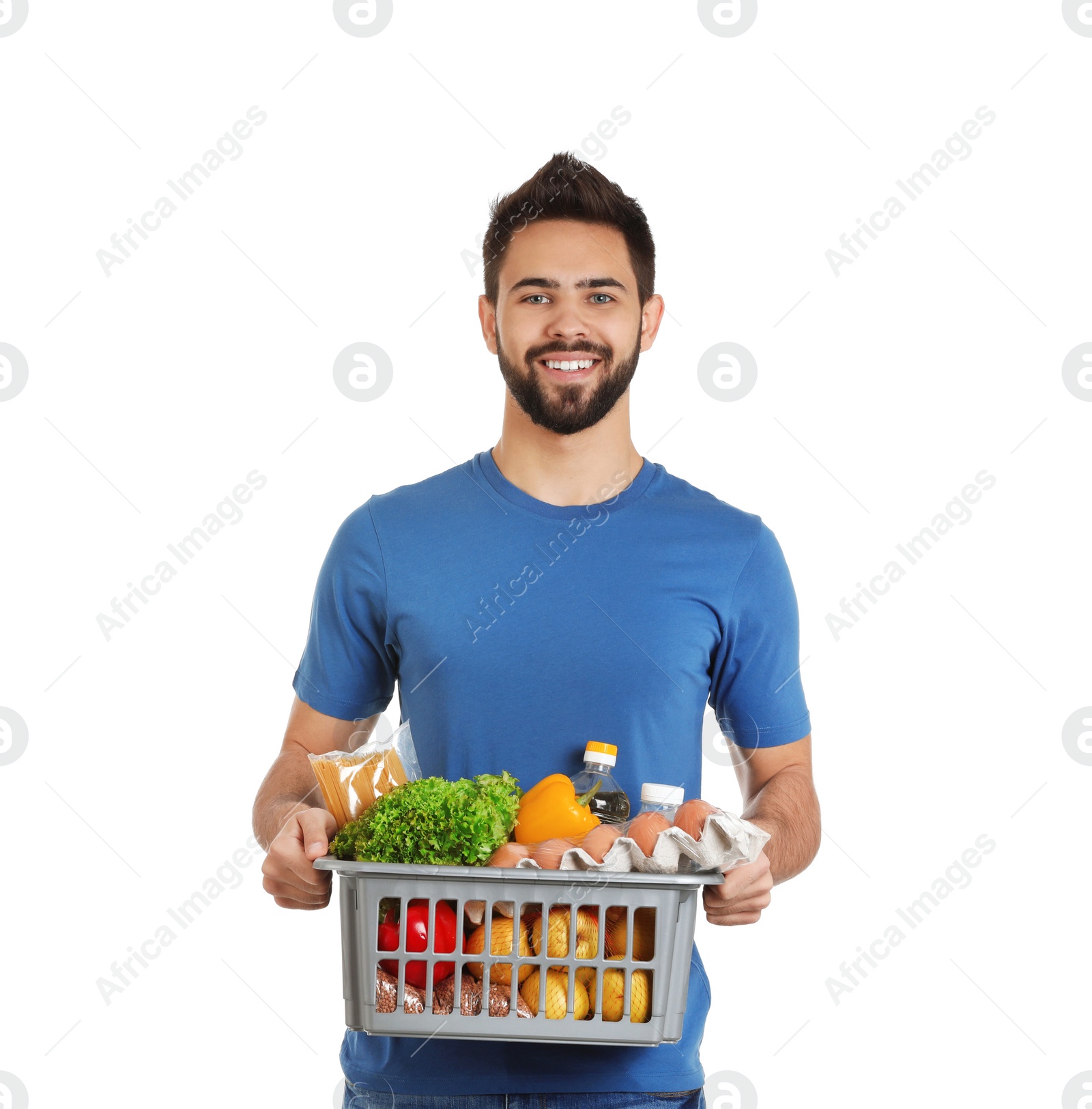 Photo of Man holding basket with fresh products on white background. Food delivery service