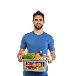 Photo of Man holding basket with fresh products on white background. Food delivery service