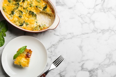 Photo of Flat lay composition with tasty broccoli casserole on white marble table. Space for text