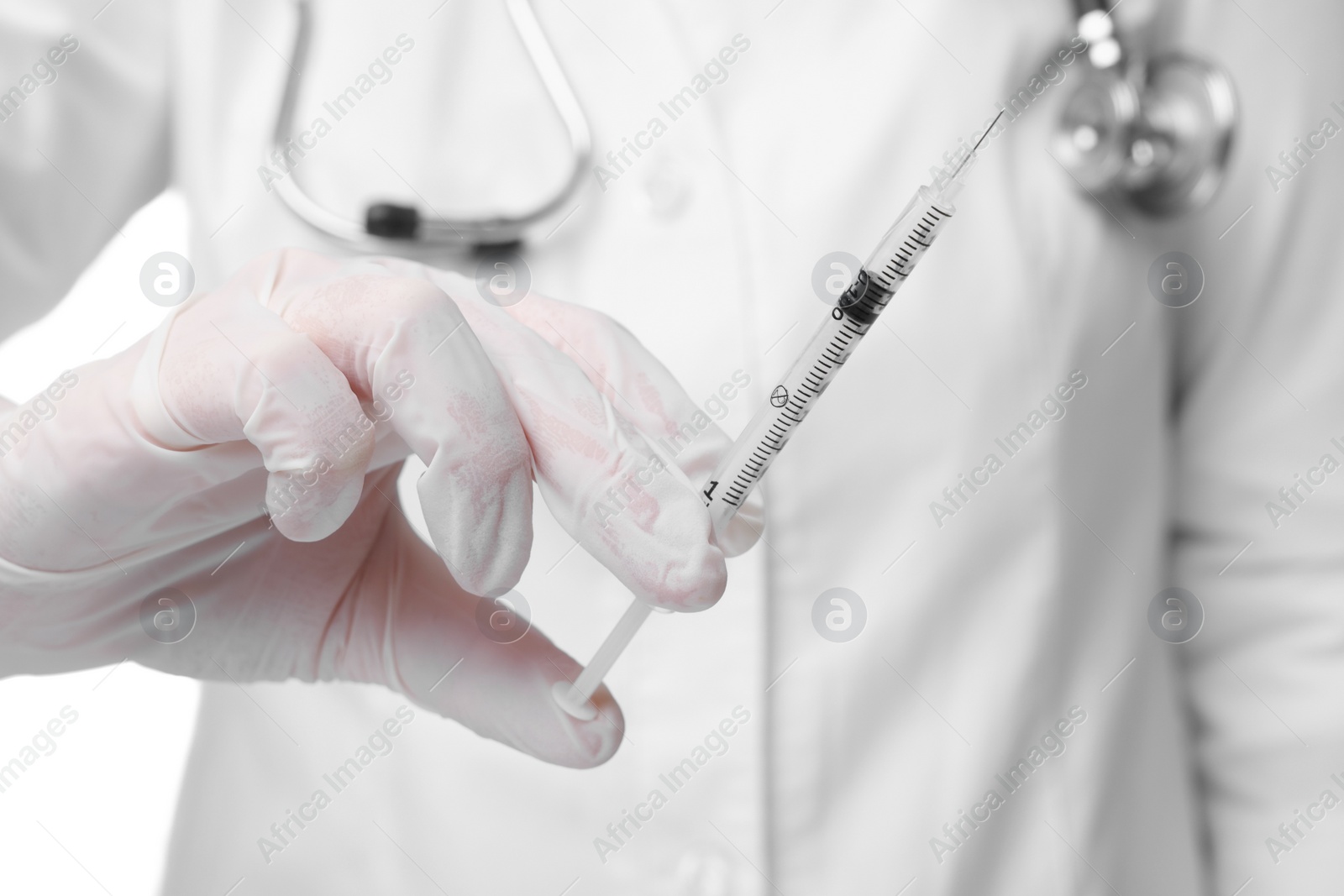 Photo of Doctor holding medical syringe with needle, closeup view