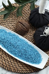 Photo of Composition with blue sea salt and herbal bags on white marble table, above view