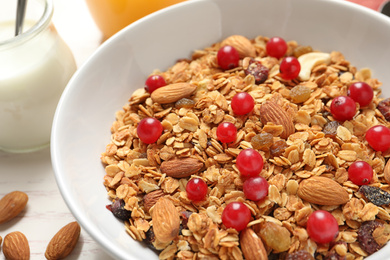 Tasty granola with cranberries on table, closeup. Healthy breakfast