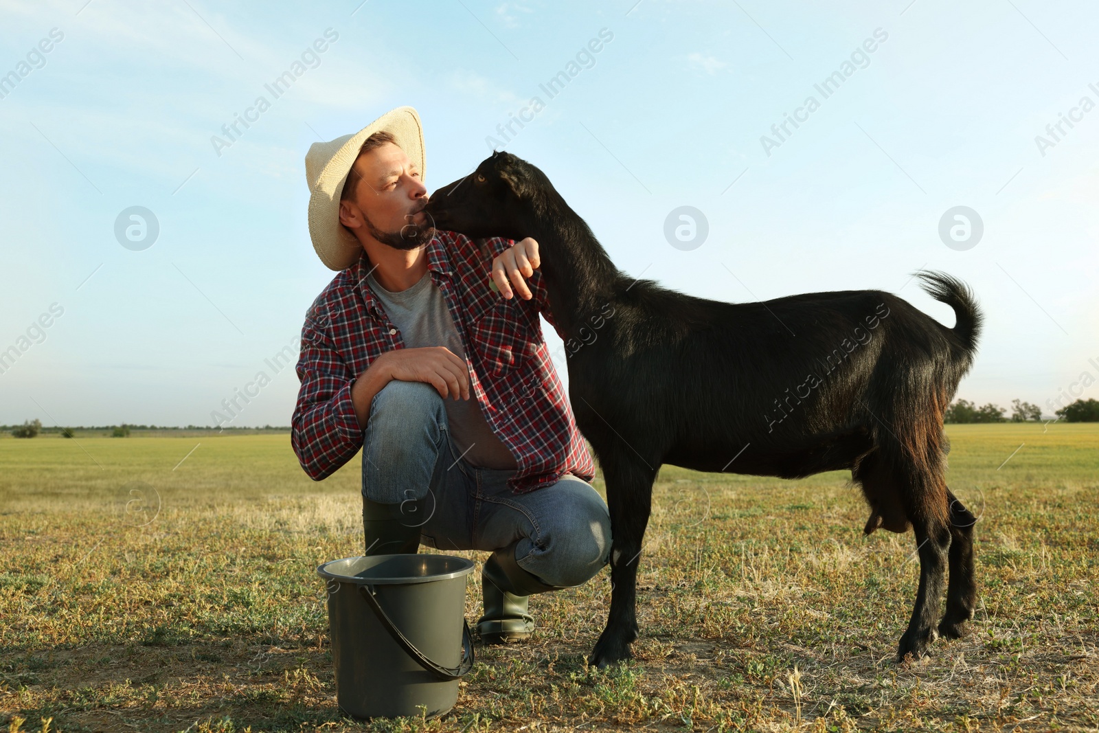 Photo of Man with goat at farm. Animal husbandry