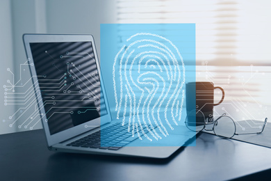 Fingerprint identification. Modern laptop on table indoors