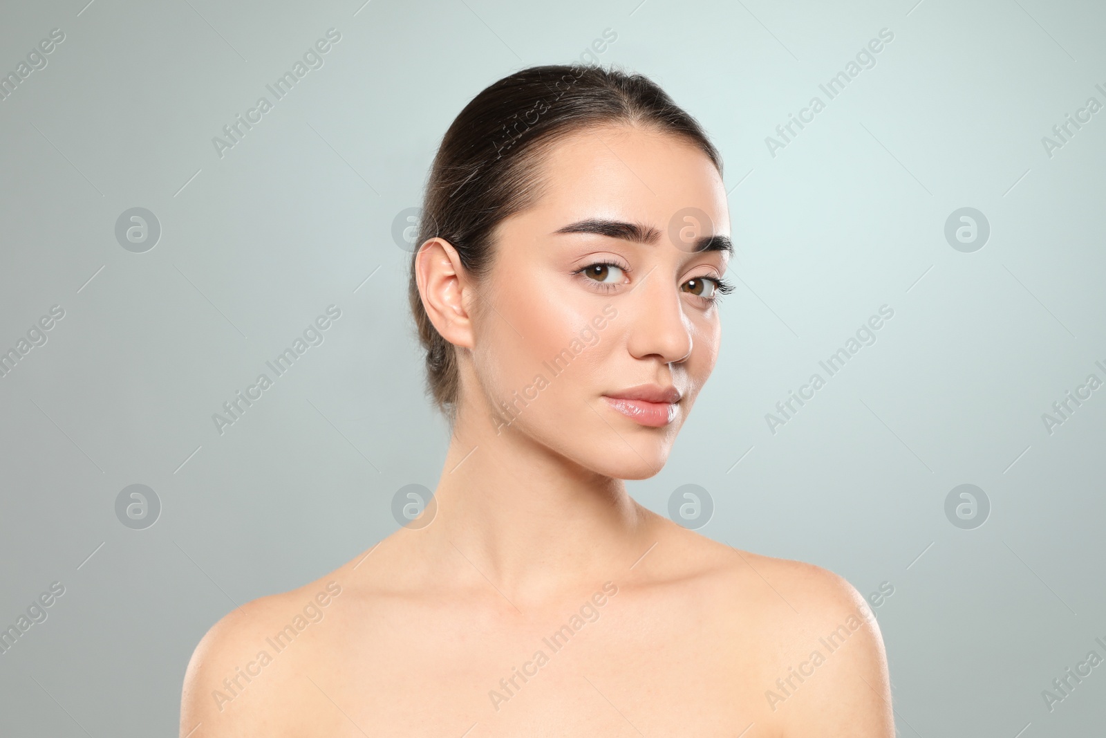 Photo of Portrait of young woman with beautiful face against color background