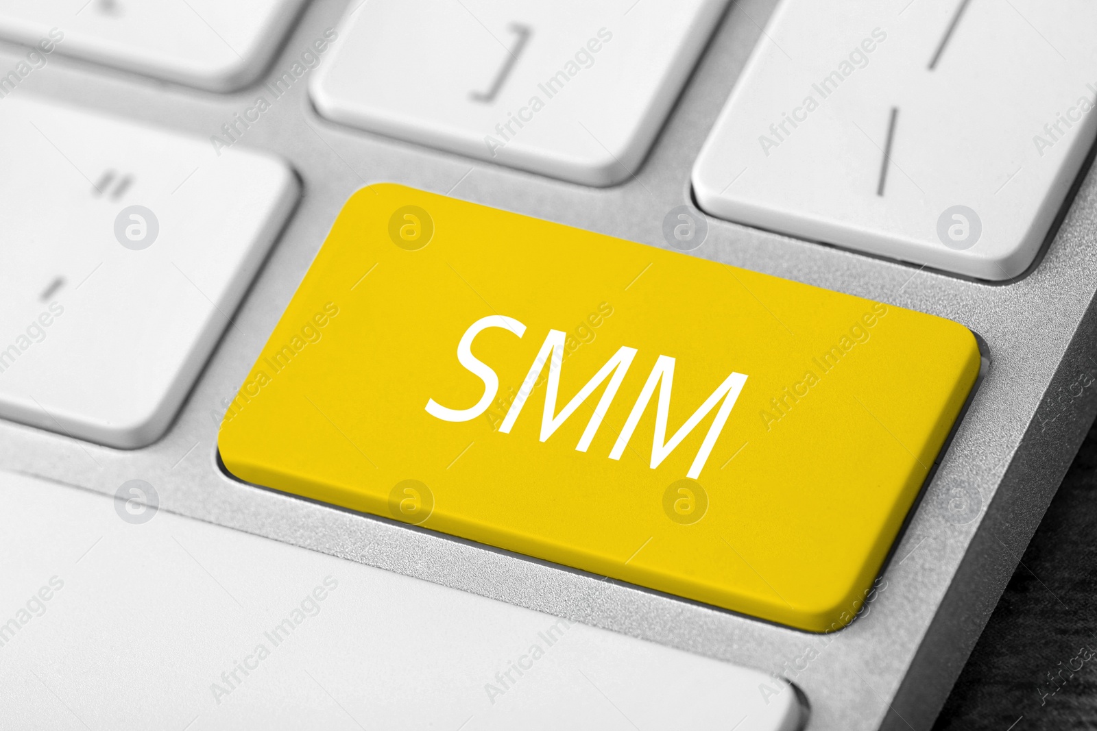 Image of Yellow button with word SMM on computed keyboard, closeup