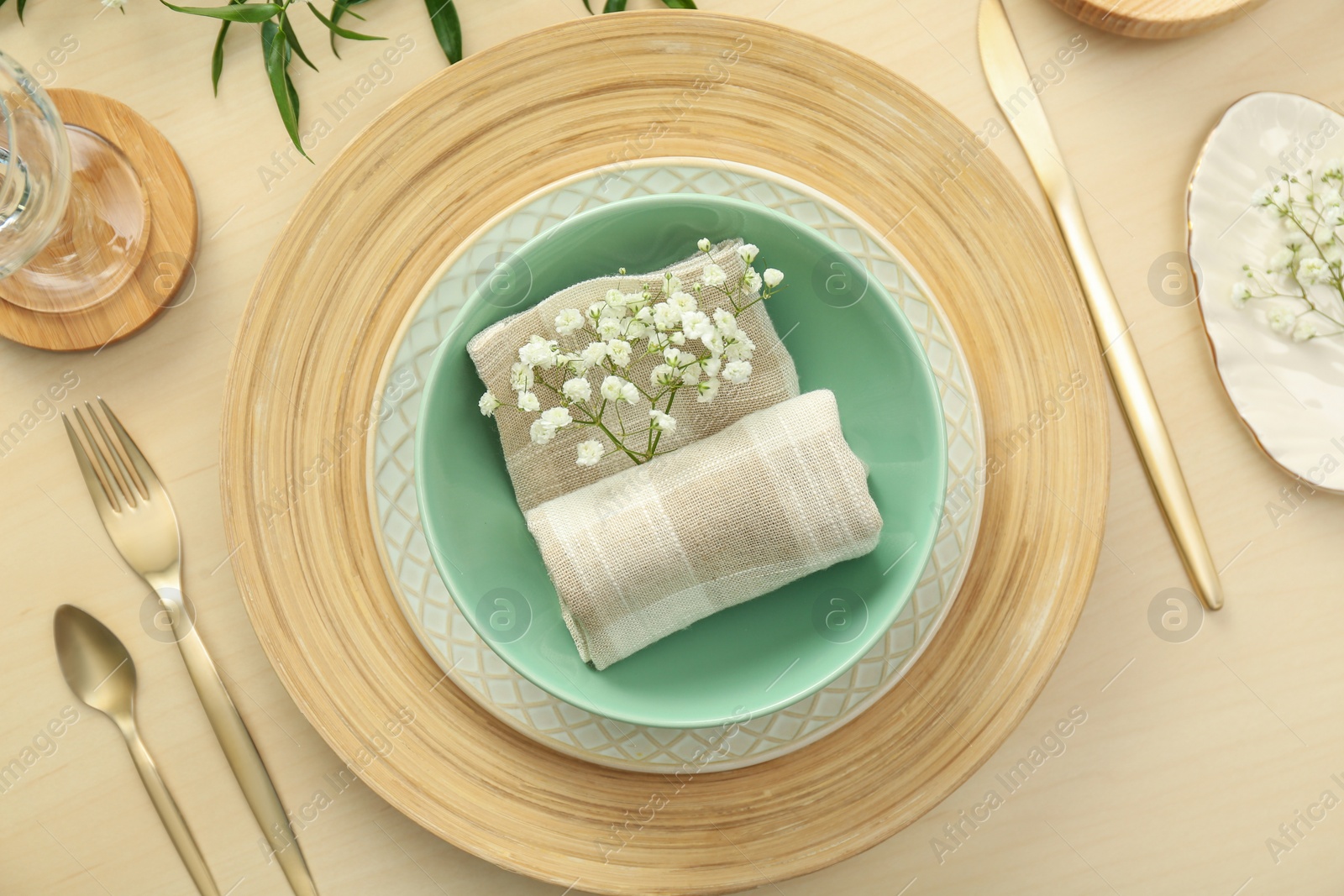 Photo of Elegant table setting with flowers and leaves, flat lay