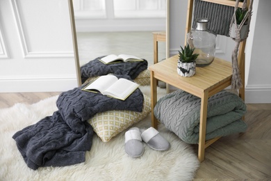 Photo of Comfortable place for rest with soft blankets and large mirror