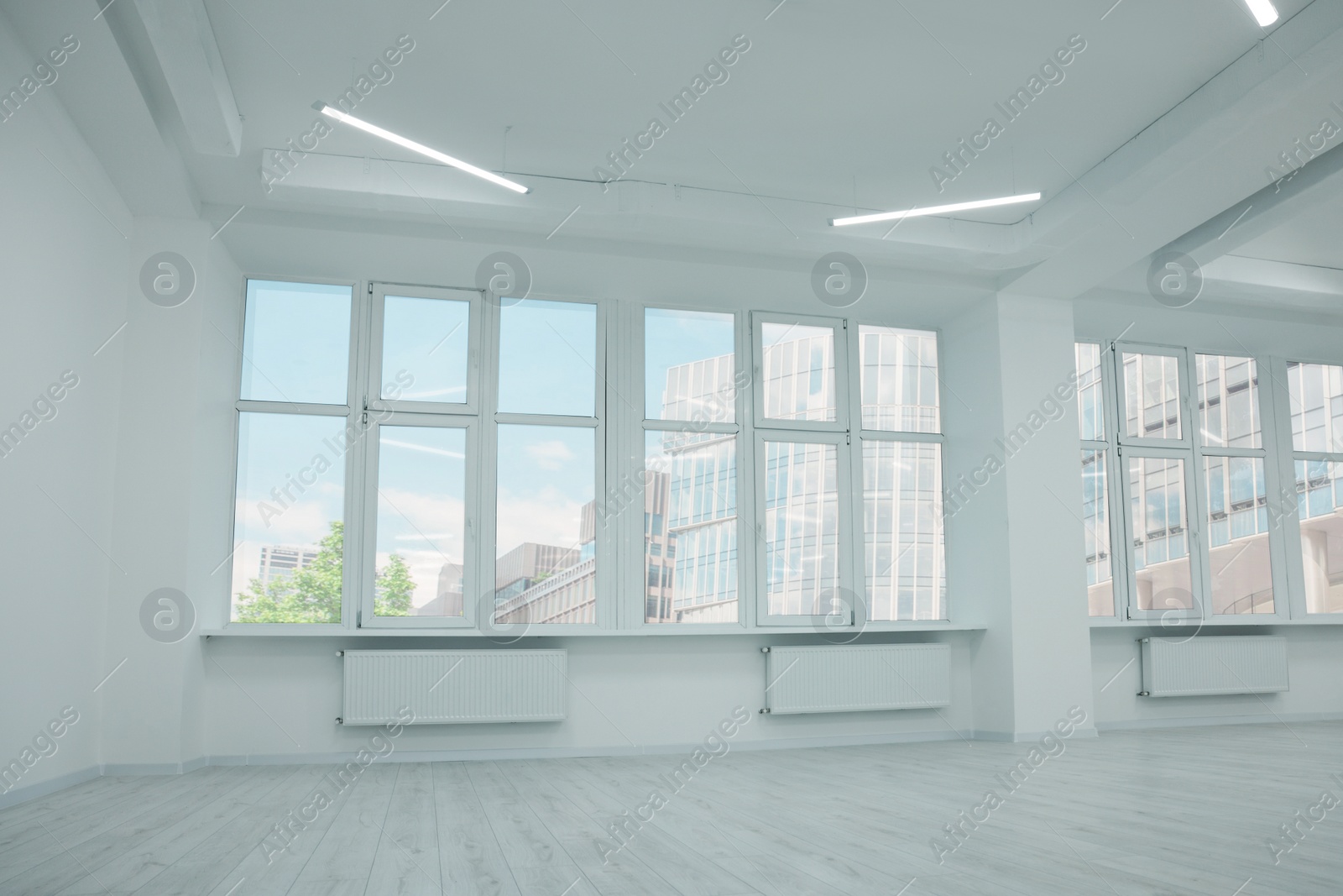 Photo of New empty room with clean windows and white walls