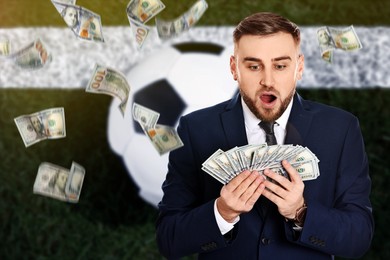 Image of Sports betting. Shocked winner holding many banknotes under flying money. Stadium with ball on background